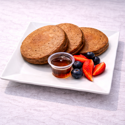 Chocolate pancake served with strawberry, blueberry and maple syrup